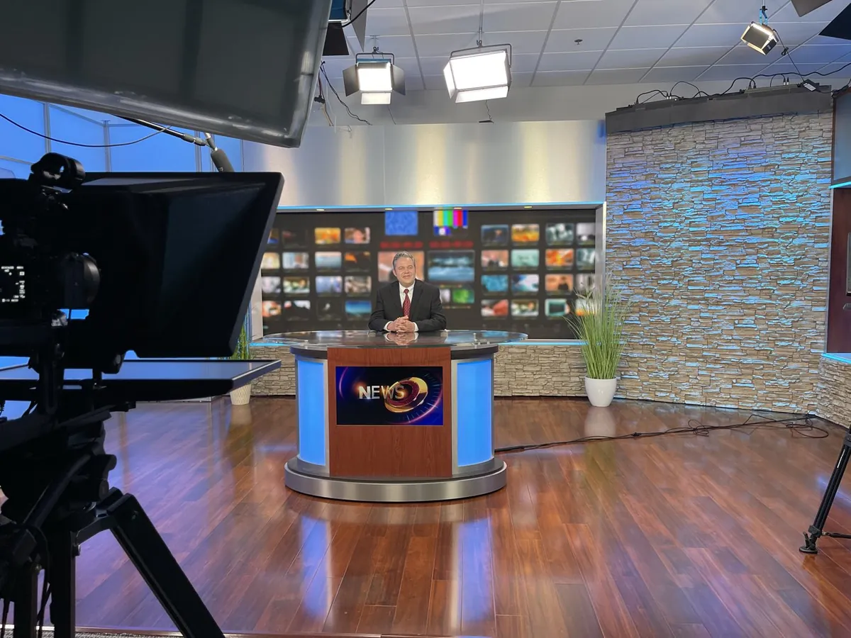 Camera, teleprompter, lighting, and presenter during a Laser Stream Video studio production