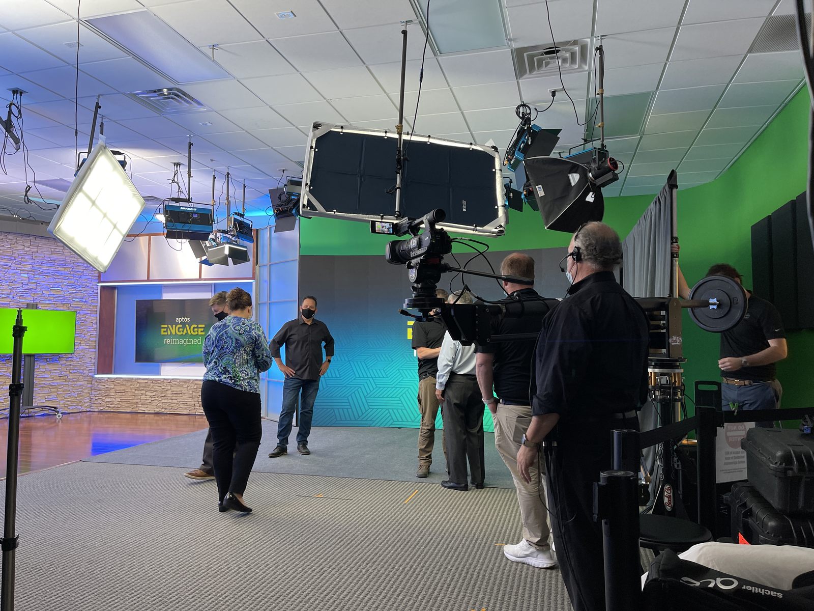 Corporate video production crew working with cameras, lighting, and a jib