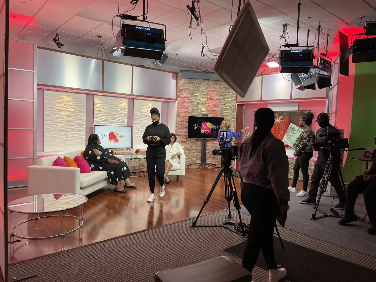 Multi-camera crew preparing a studio interview and video podcast set