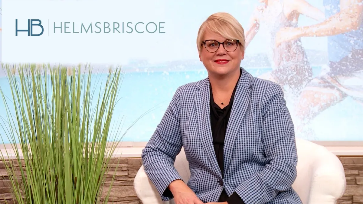 Business expert recording a direct-to-camera interview on a branded studio set